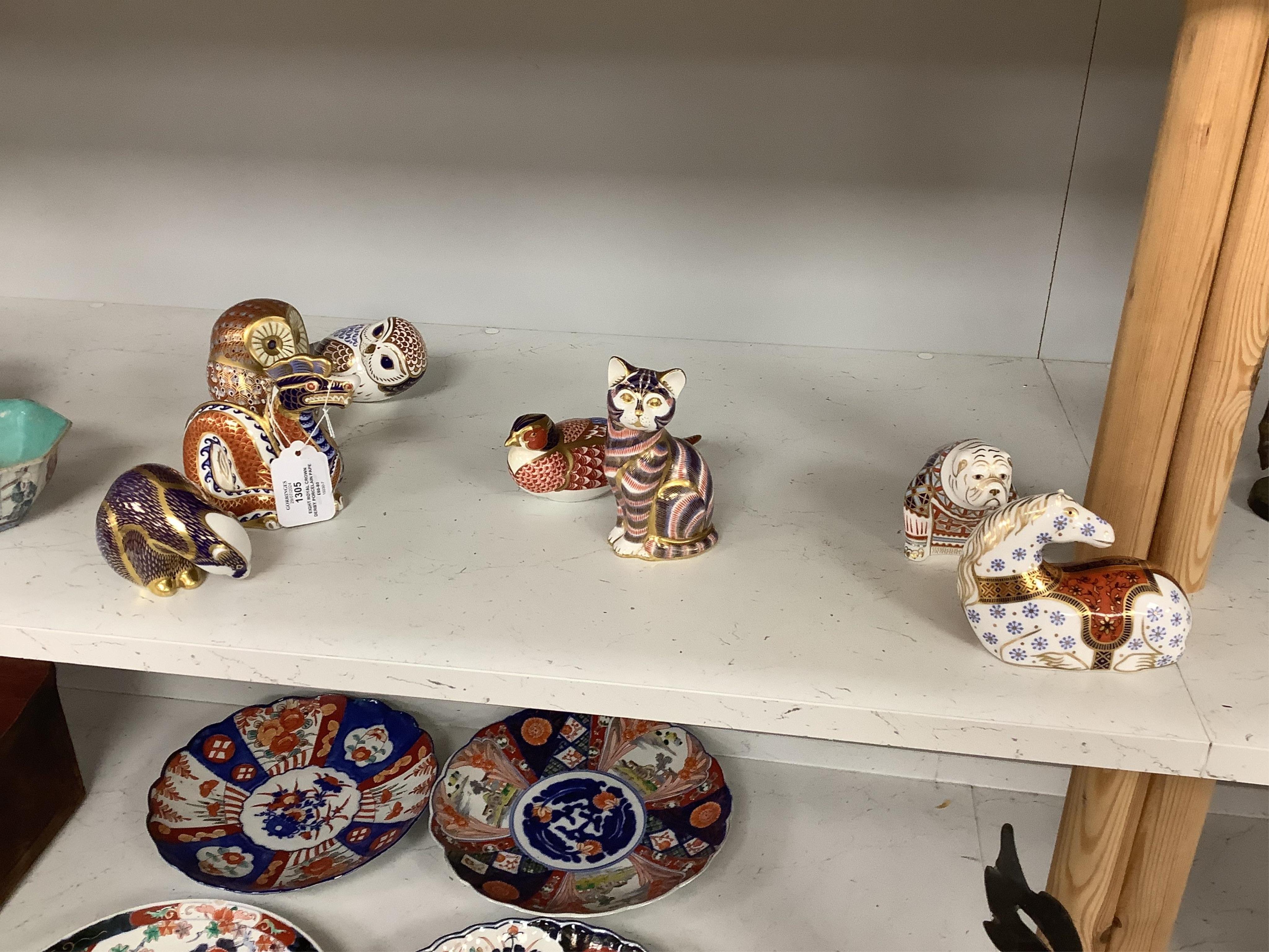 Eight Royal Crown Derby porcelain paperweights in the form of animals including a cat, badger and owl, largest 13.5cm high. Condition - good